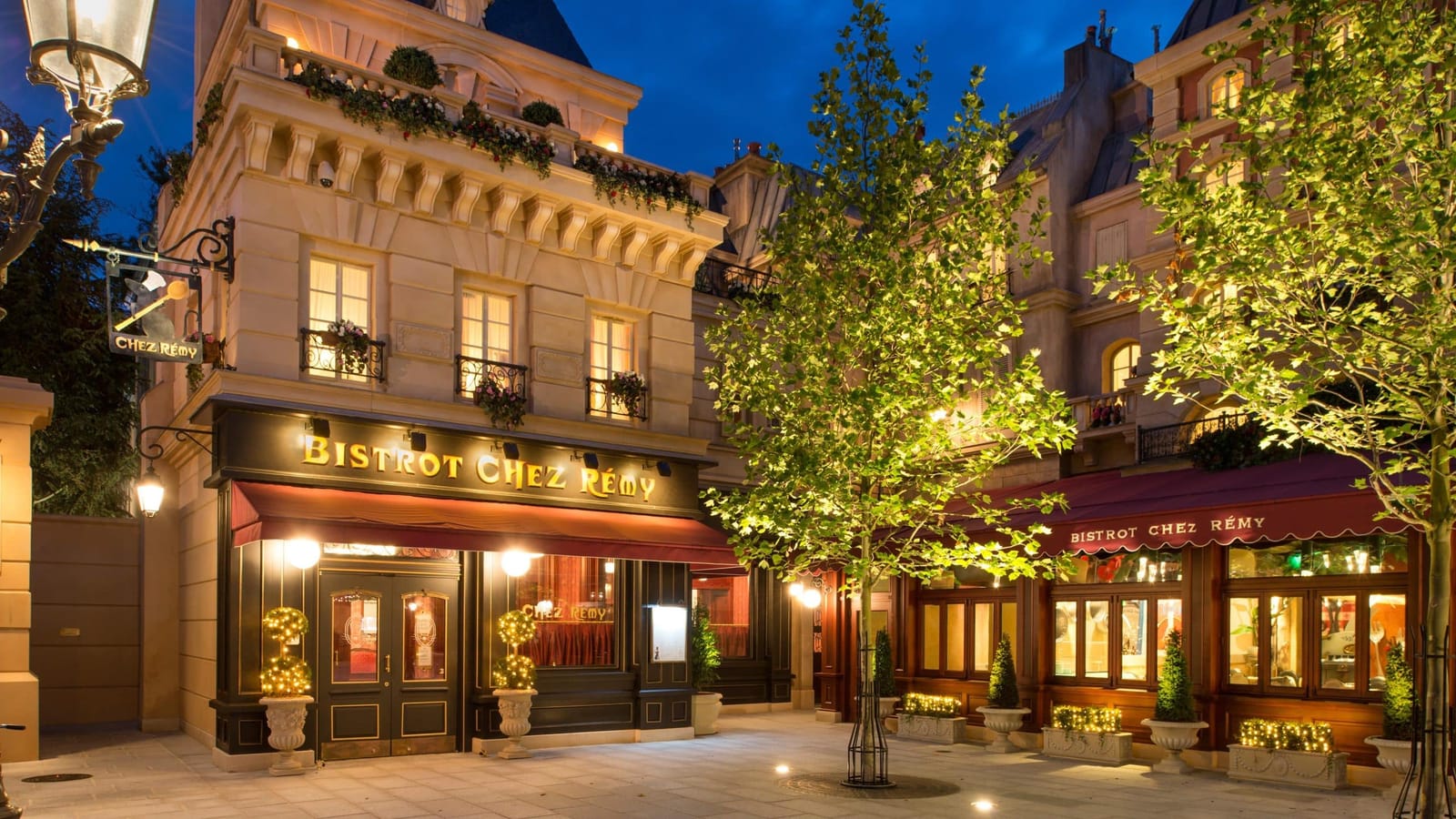 Salle du Bistrot chez Rémy dans Worlds of Pixar, décor miniaturisé avec ustensiles de cuisine géants, capsules de bouchons de champagne en guise de sièges et boiseries Art Déco surdimensionnées